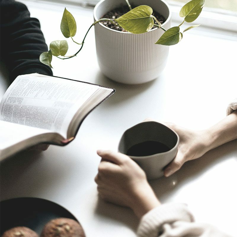 woman reading bible with coffee